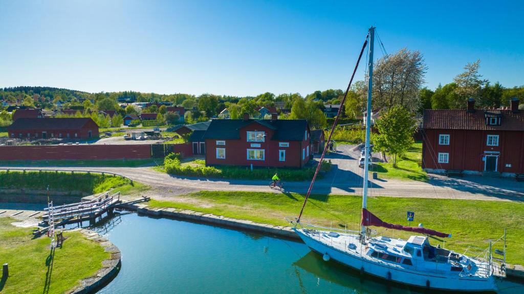 una barca ormeggiata in un porto turistico di fronte a una casa di Byggmästare Villan a Motala