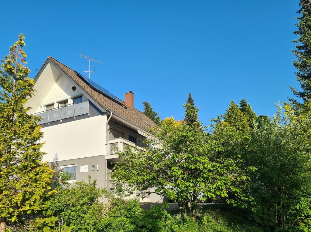 a white building with trees in front of it at Ferienwohnung mit toller Aussicht in Albstadt