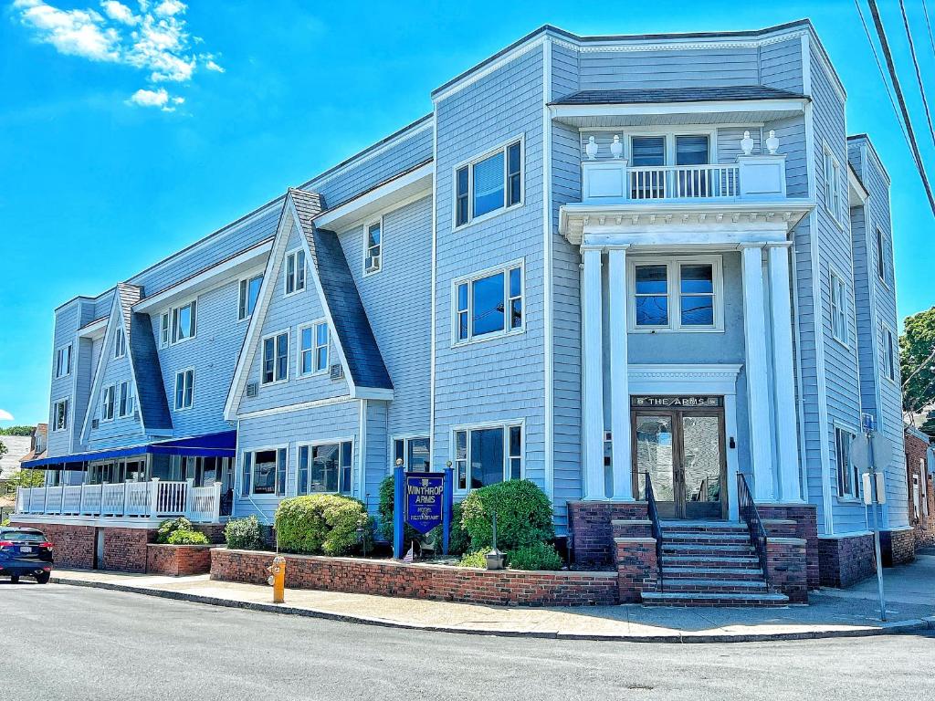 a blue house on the side of a street at Winthrop Arms Hotel Restaurant Logan Airport in Winthrop