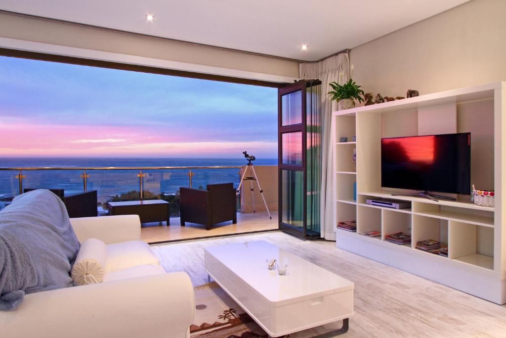 
a living room filled with furniture and a tv at Sea Mount in Cape Town
