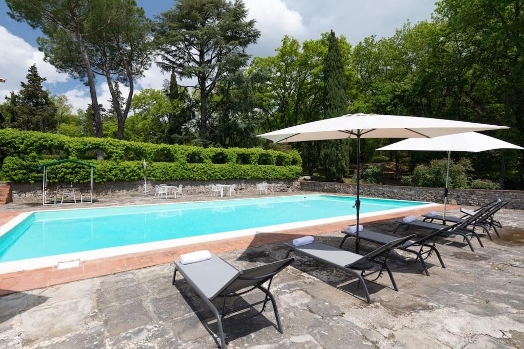 - une piscine bordée de chaises longues et de parasols dans l'établissement Casa nel cuore del Chianti, à Gaiole in Chianti