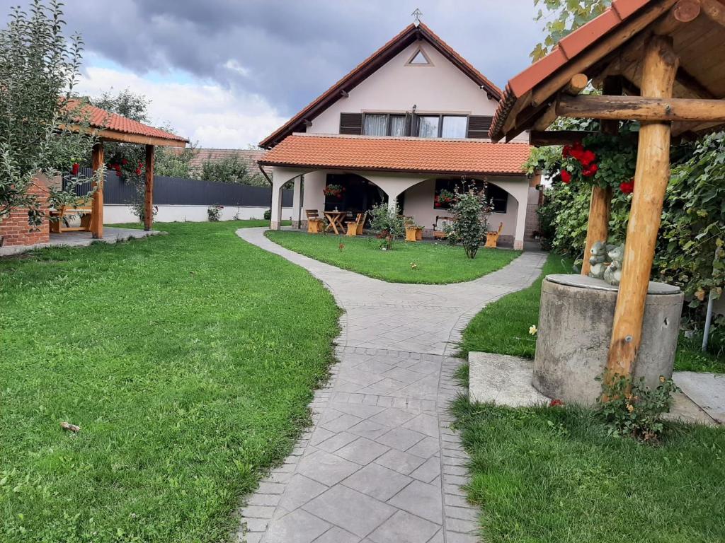 a walkway in front of a house at Pensiunea Simona in Sîmbăta de Sus
