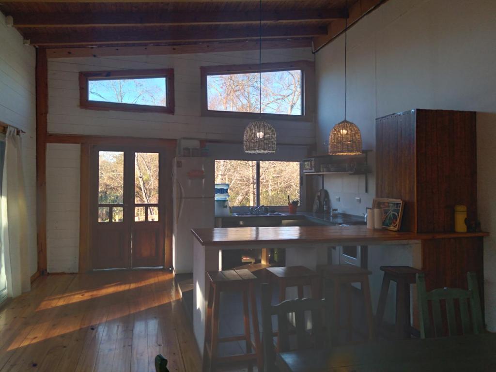 a kitchen with a counter and stools in a room at Delta tigre in Tigre