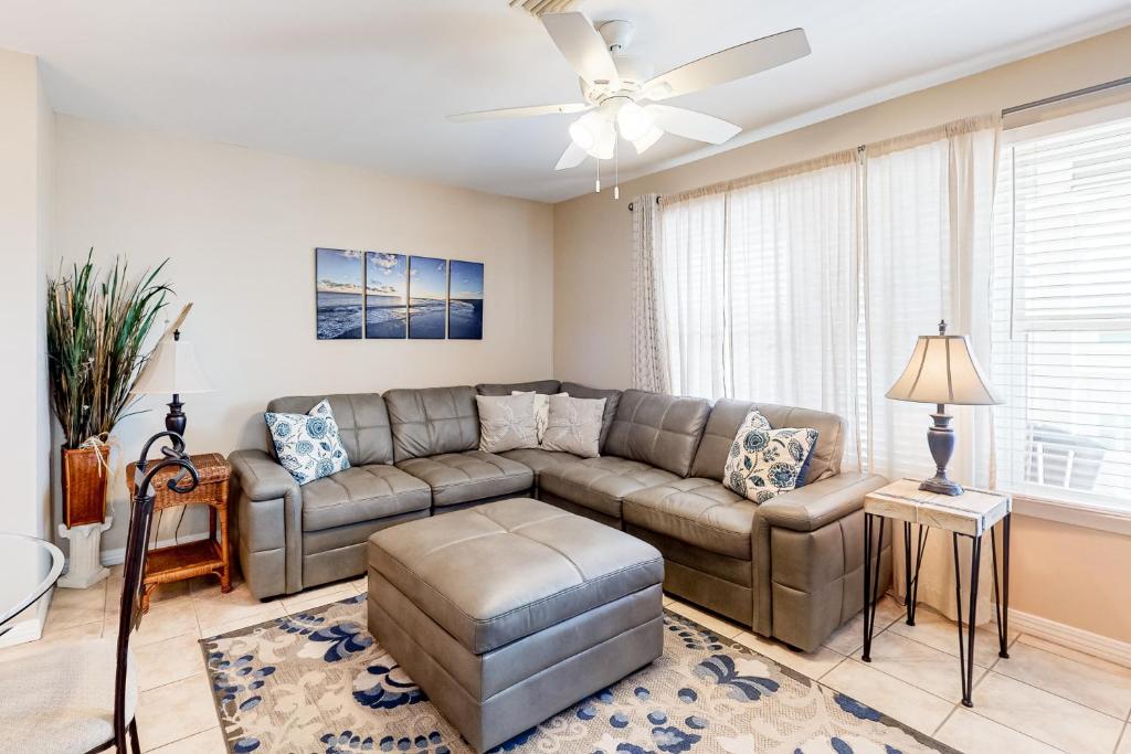 a living room with a couch and a ceiling fan at Three C's 202 in Gulf Shores