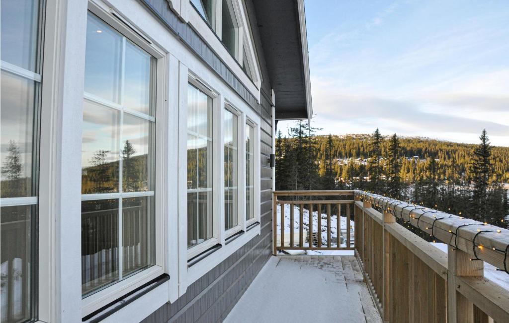 a balcony of a house with a view of the mountains at Nice Home In Slen With Sauna And 7 Bedrooms in Sälen