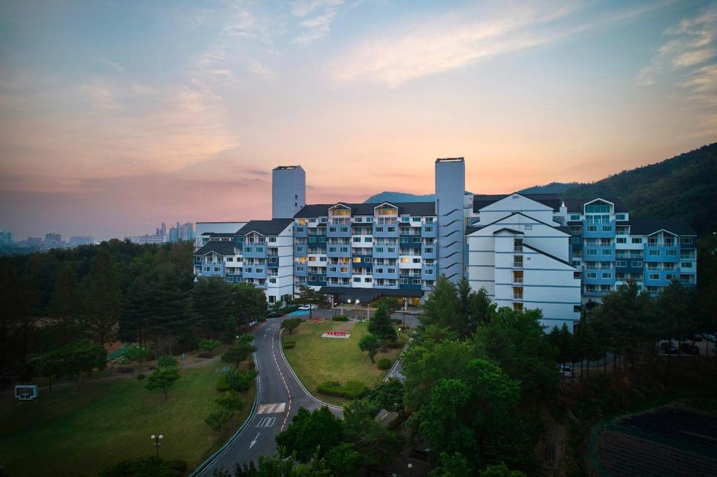 a large apartment building with a road in front of it at Kumho Seorak Resort in Sokcho