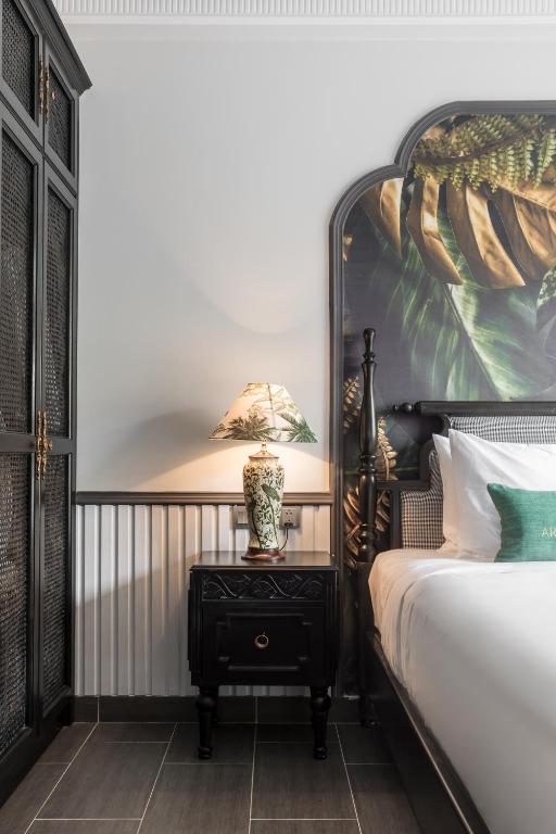 Postel nebo postele na pokoji v ubytování ARTIS Hotel Da Lat