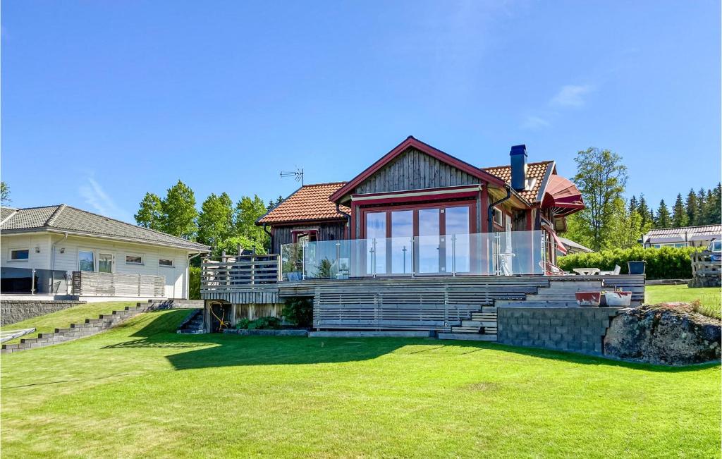 a house with a large lawn in front of it at Amazing Home In Nssj With House Sea View in Nässjö