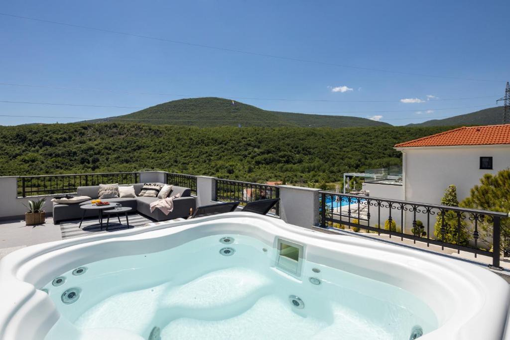 a hot tub on the balcony of a house at 3 Luxury bedroom Apartment EMMA in Sinj