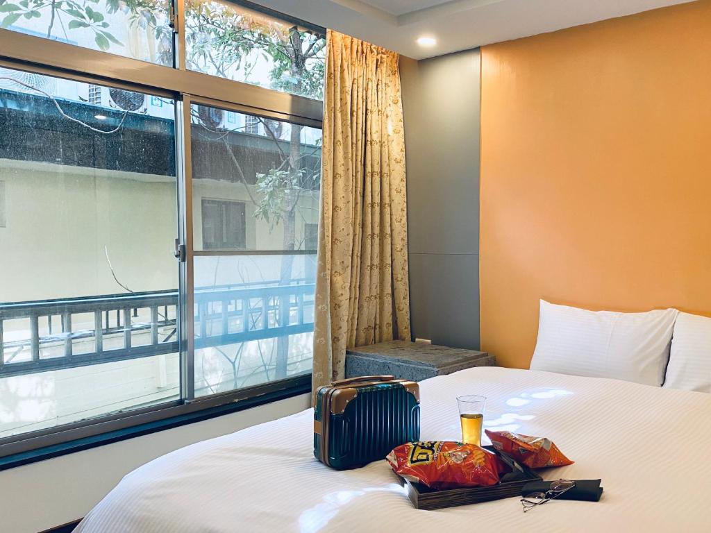 a hotel room with a bed with a window at Spa Spring Resort in Taipei