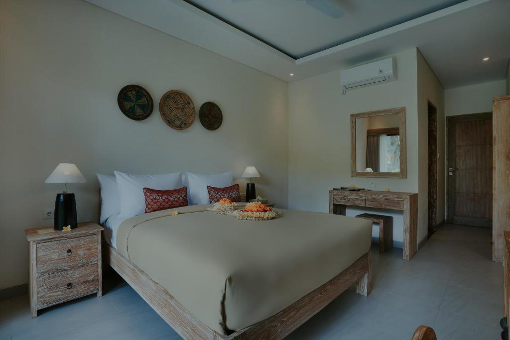 Postel nebo postele na pokoji v ubytování LASTANA SUITE UBUD