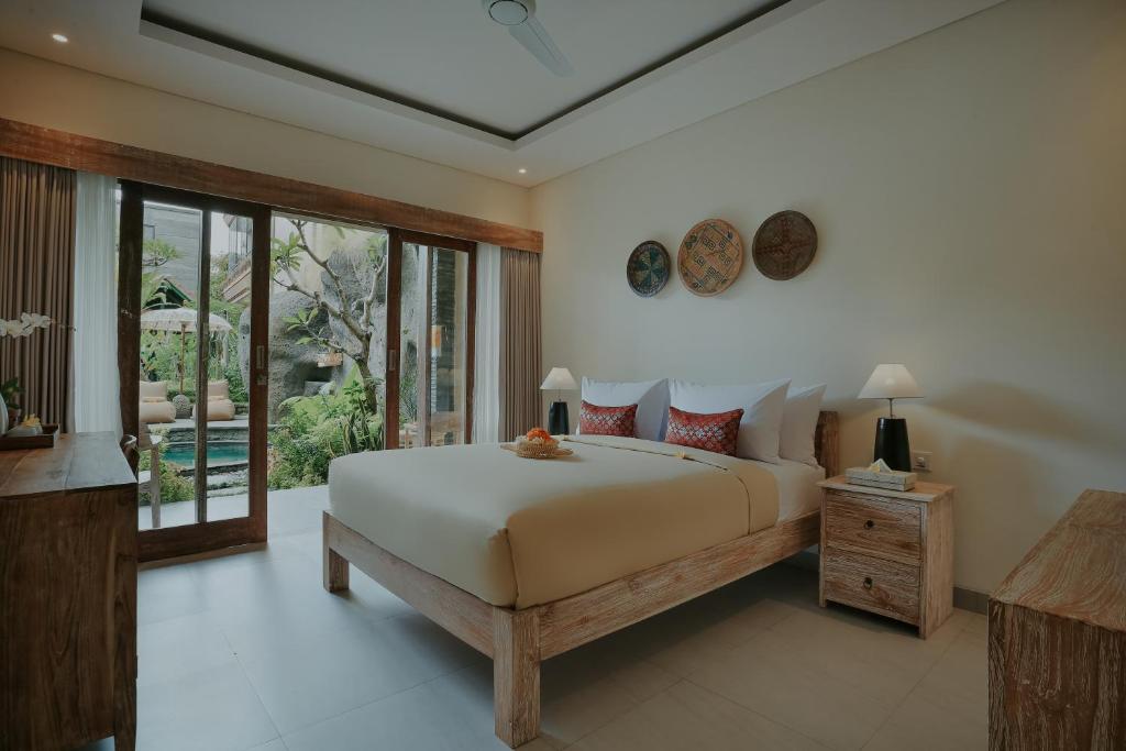 Postel nebo postele na pokoji v ubytování LASTANA SUITE UBUD