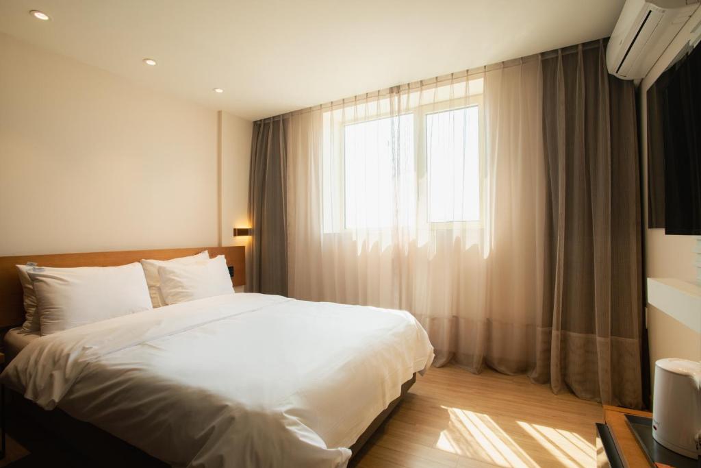 Postel nebo postele na pokoji v ubytování Winners Hotel
