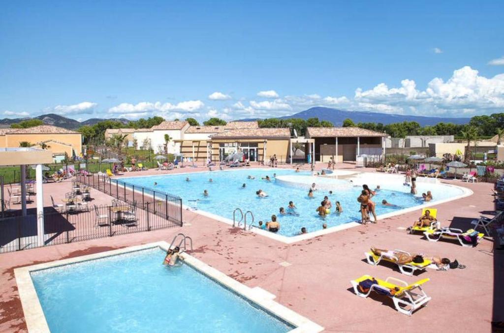 a group of people in a pool at a resort at Les demeures du Ventoux in Aubignan