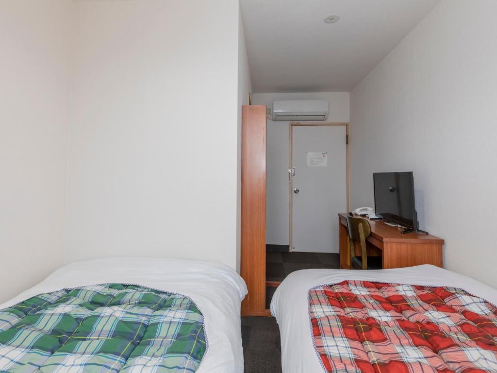 Postel nebo postele na pokoji v ubytování Tabist Hotel Yakumo Matsue