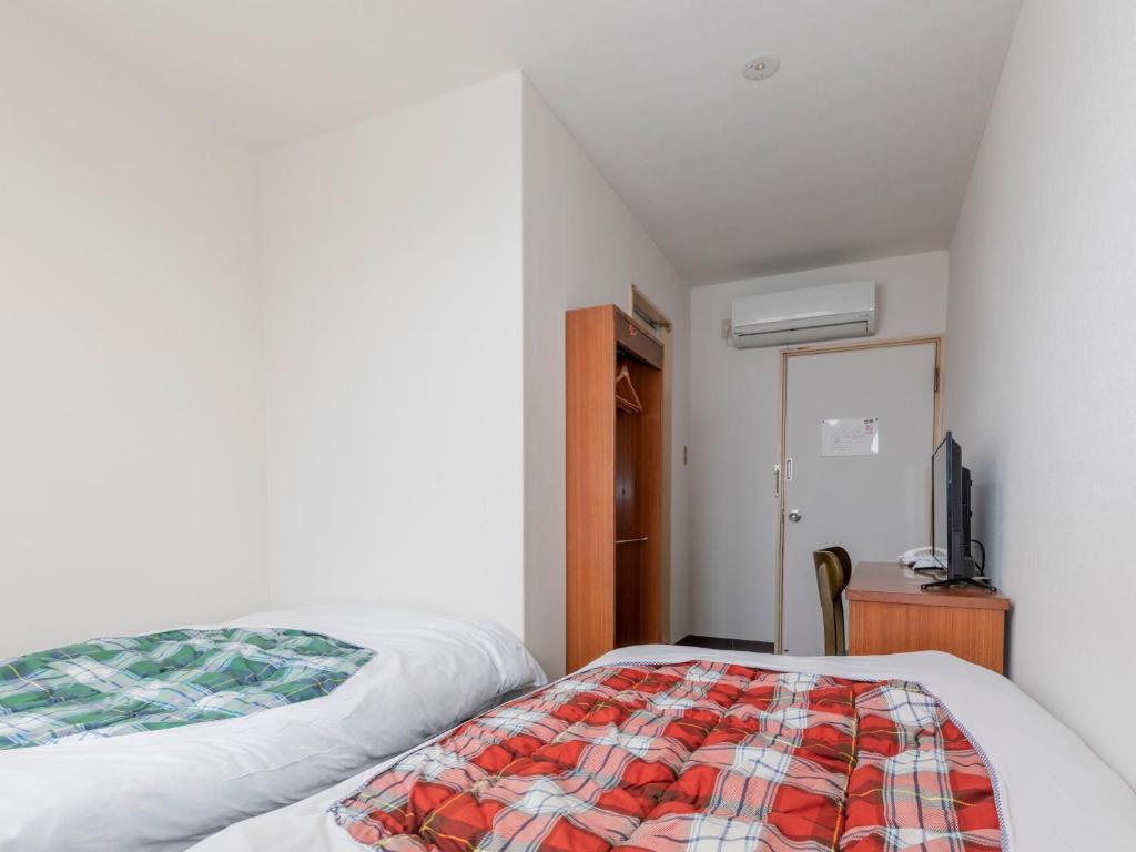 Postel nebo postele na pokoji v ubytování Tabist Hotel Yakumo Matsue