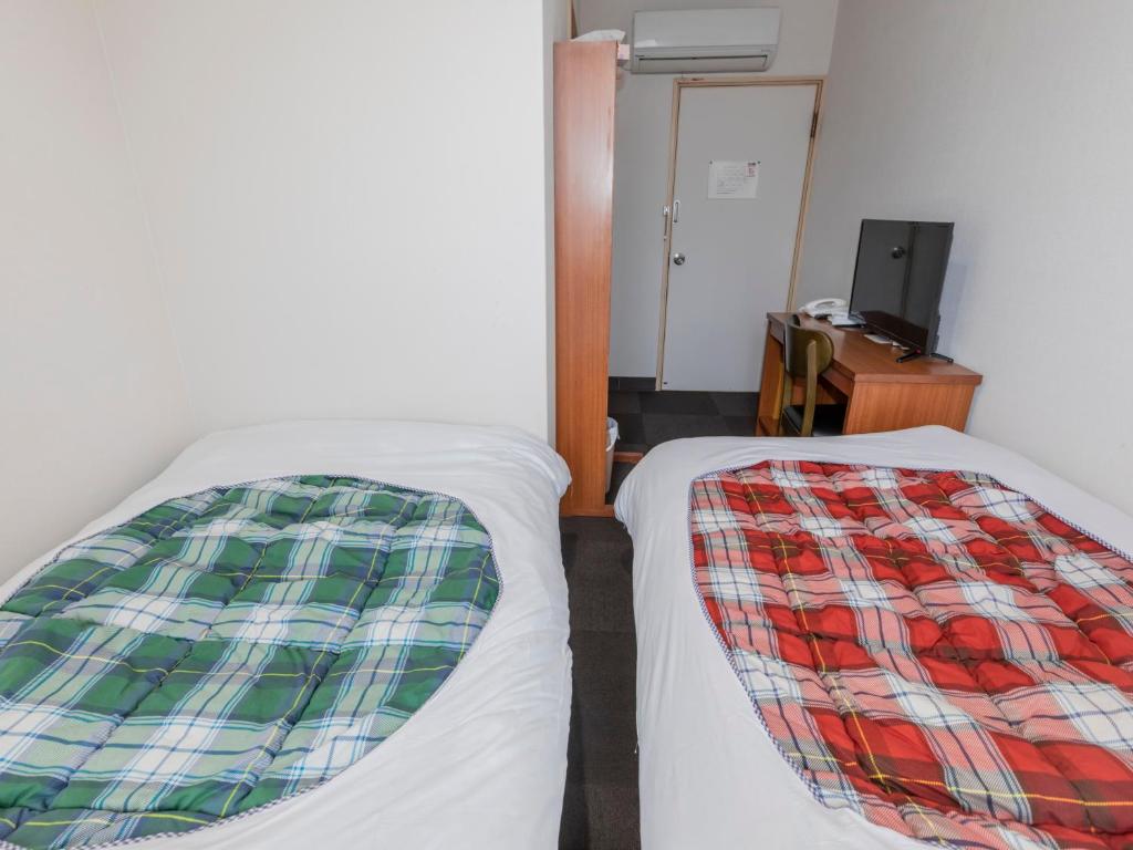 Postel nebo postele na pokoji v ubytování Tabist Hotel Yakumo Matsue