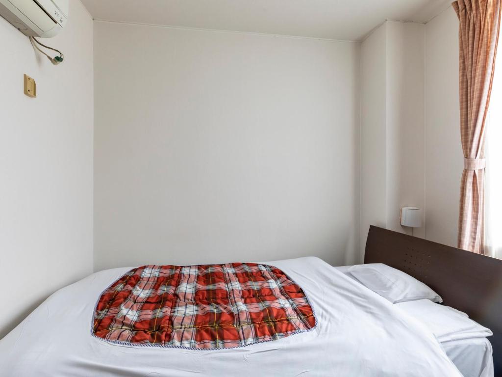 Postel nebo postele na pokoji v ubytování Tabist Hotel Yakumo Matsue