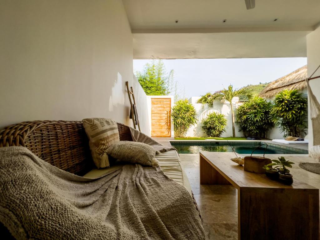 a living room with a couch and a table at Kai Villas Lombok in Kuta Lombok