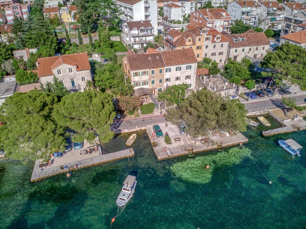 an aerial view of a house with a boat in the water at Stone Home Kotor in Dobrota