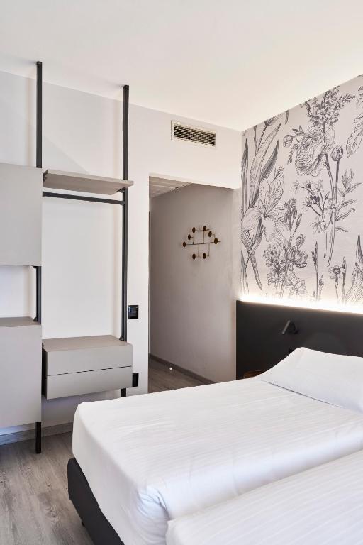 Postel nebo postele na pokoji v ubytování Hotel Astoria