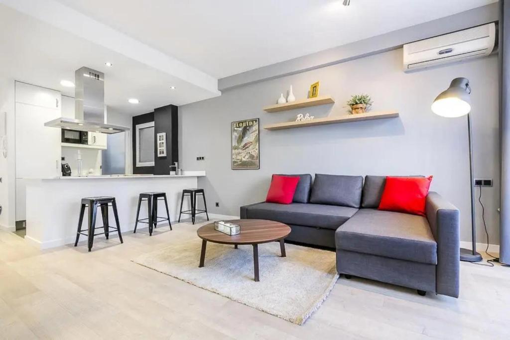 a living room with a couch and a table at 51SAM1021 - Modern apartment near Montjuic in Barcelona