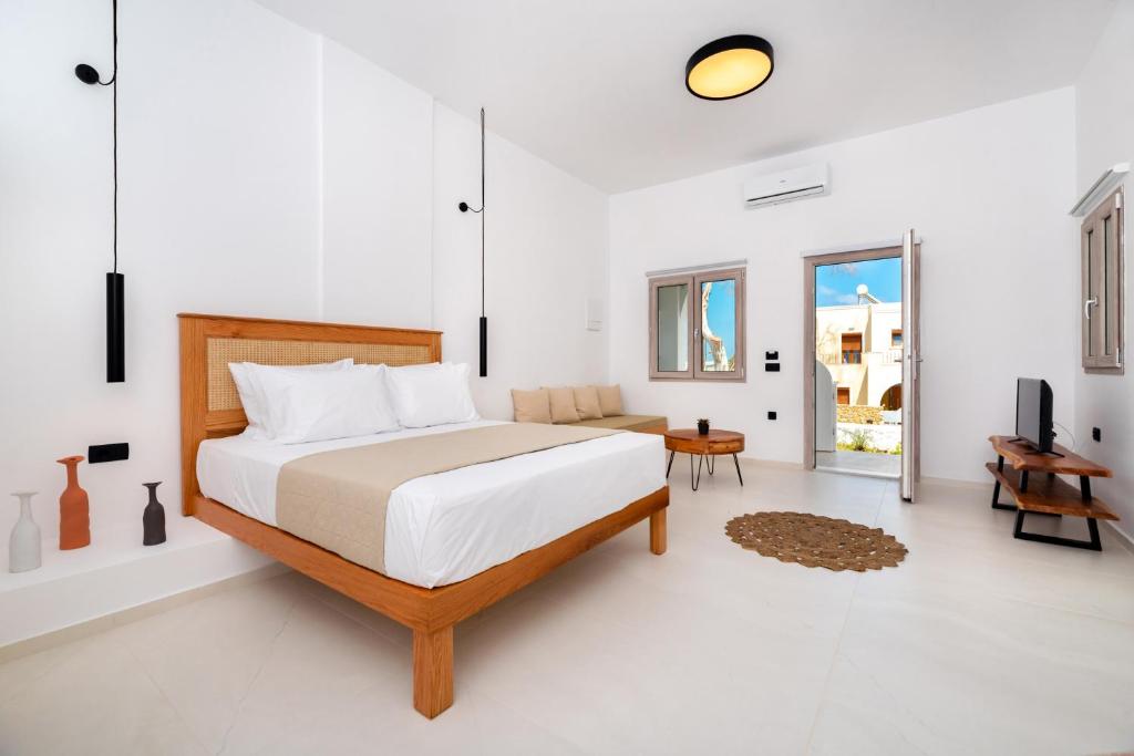a bedroom with a bed and a living room at Centrio Fira Suites in Fira