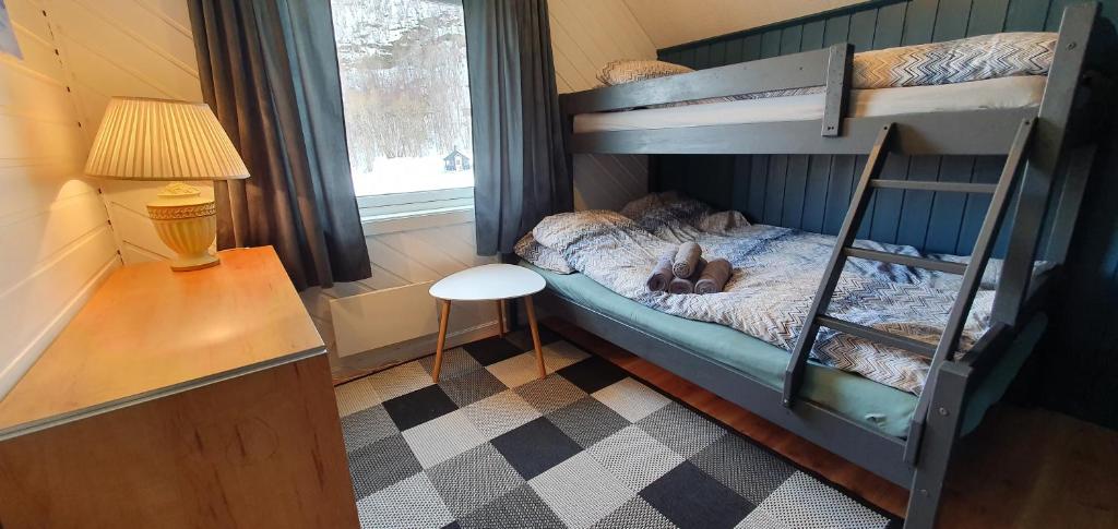 a bed room with two beds and a window at Arctic FjordCamp in Burfjord