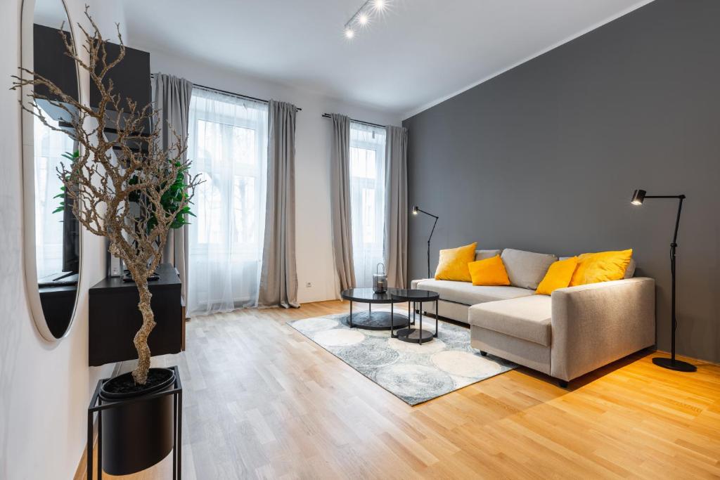 a living room with a couch and a table at Trendy apt with - smart TV, coffee machine in Meidling in Vienna