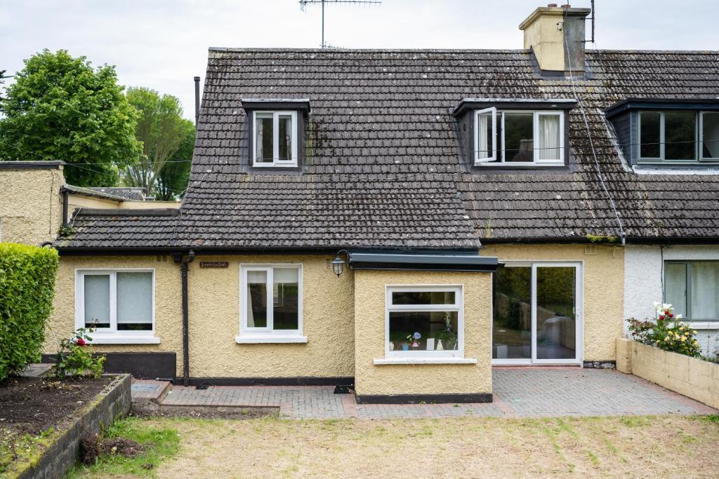 a house with white windows and a roof at Gleann Na Smol in Howth