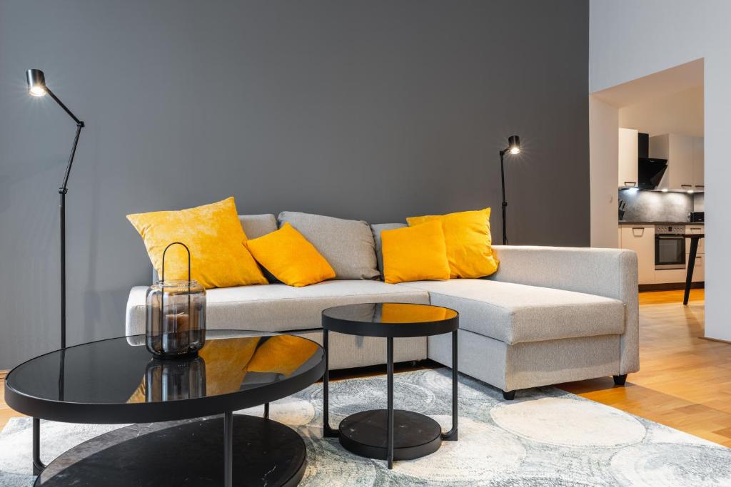 a living room with a couch and a table at Trendy apt with - smart TV, coffee machine in Meidling in Vienna