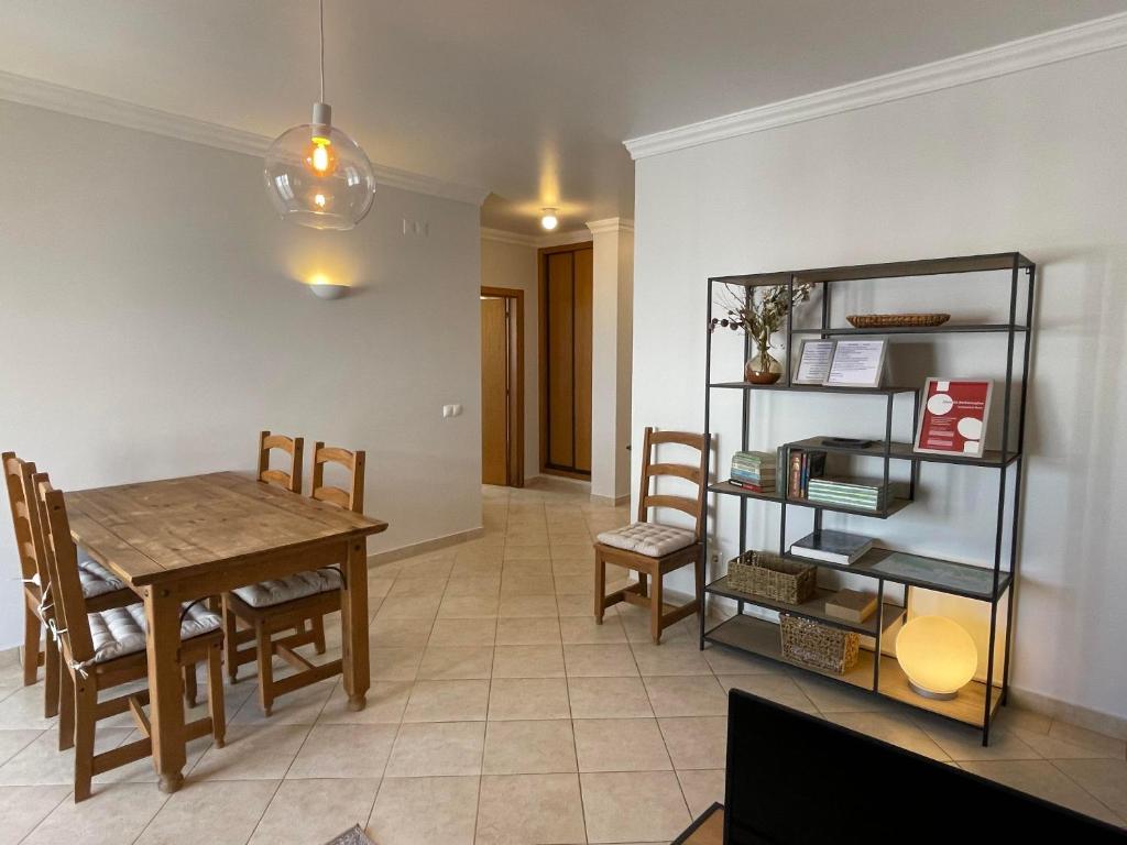 a kitchen and dining room with a table and chairs at Beachfront T1 in Armação de Pêra