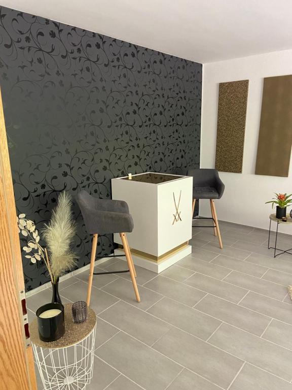 a room with two chairs and a black wall at City Apartment #2 bei der Porzellan Manufaktur in Meißen