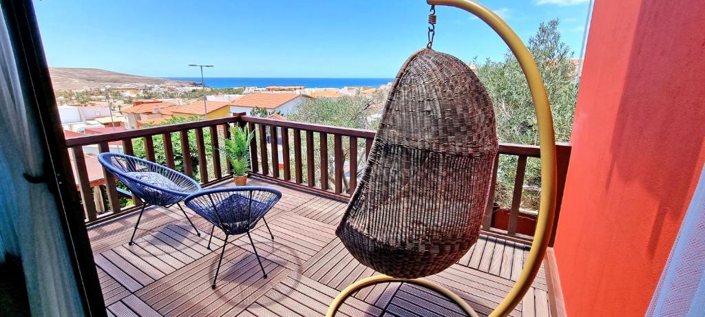 a net hanging on a balcony with two chairs at CASA BALIMAR in Tarajalejo