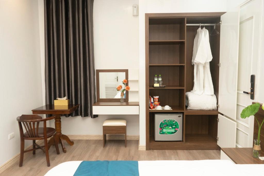 Postel nebo postele na pokoji v ubytování Sen Hotel My Dinh Song Da 미딩