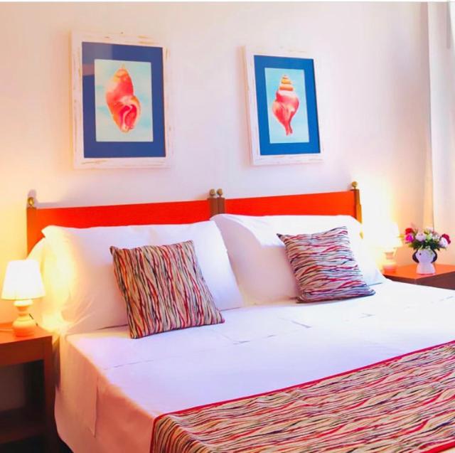 a bedroom with a bed, a desk and a painting on the wall at Hotel Rio Sul Mare in Rio Marina