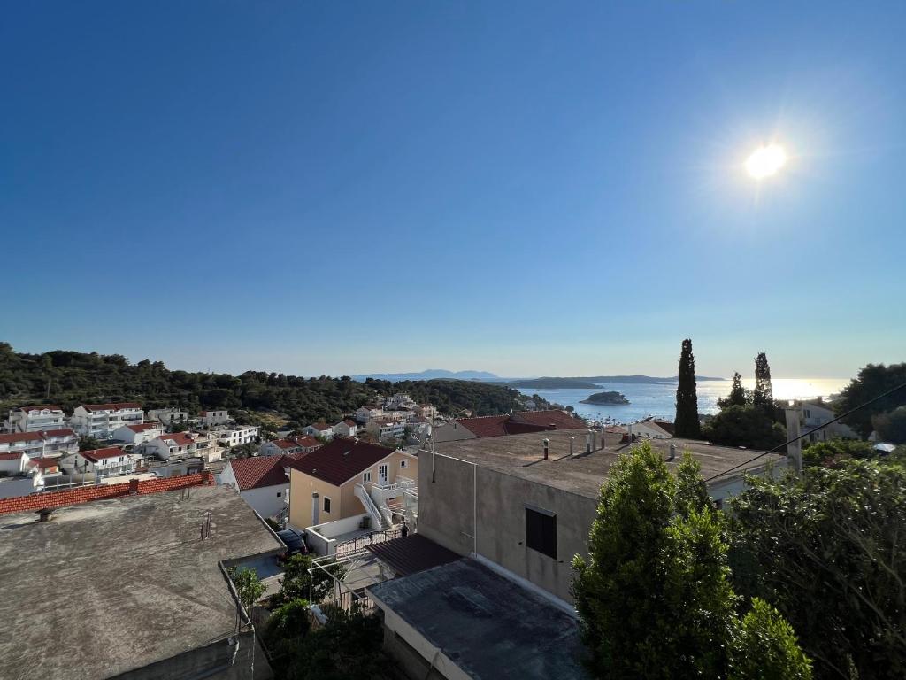 a view of a town with the ocean in the background at Apartments and Rooms Jasna in Hvar