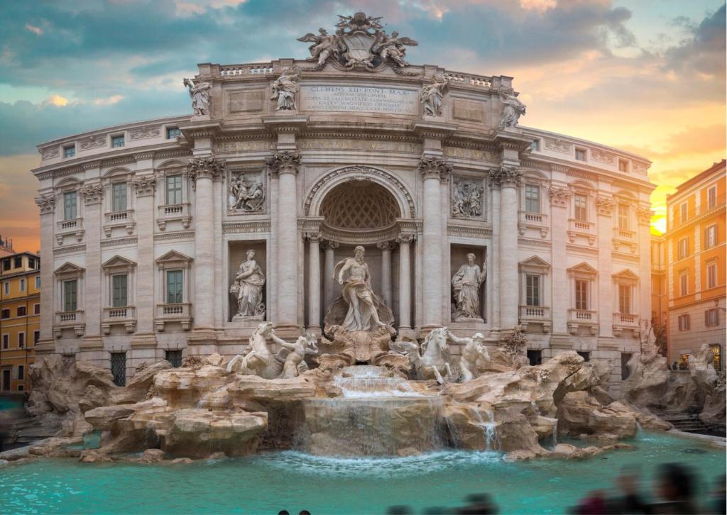 a large building with a fountain in front of it at Persia Collection Trevi in Rome