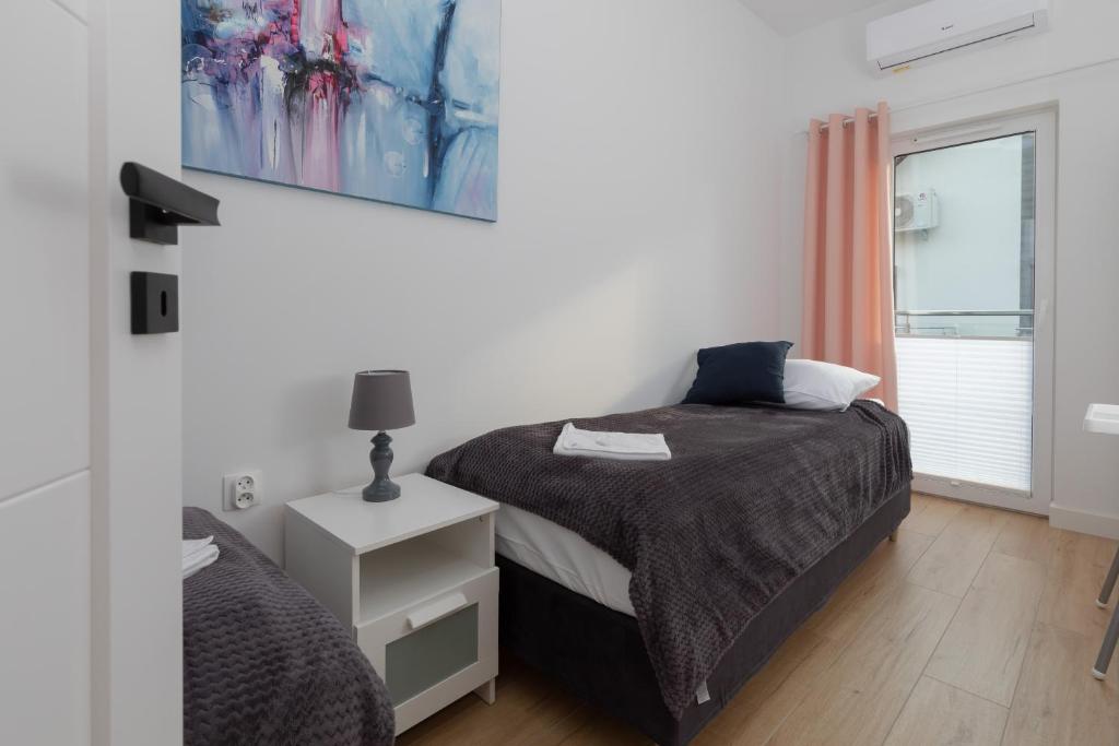 Postel nebo postele na pokoji v ubytování Horizon Park Apartment by Noclegi Renters