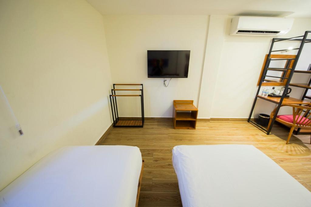 Postel nebo postele na pokoji v ubytování The Point Boutique Hotel
