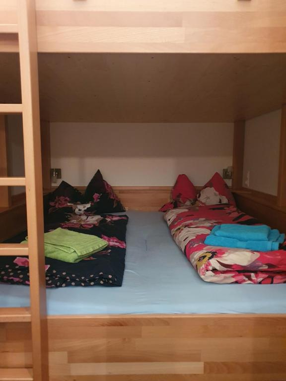 two beds in a bunk bed with pillows on them at Höss-Alpin-Lodge in Hinterstoder