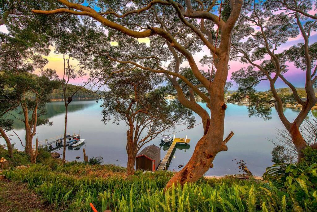 a view of a lake with a boat in the water at Phegans Bay Waterfront Retreat in Blackwall