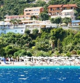 a view of a beach with umbrellas and a resort at VASILIKI SeaMemories in Barbati