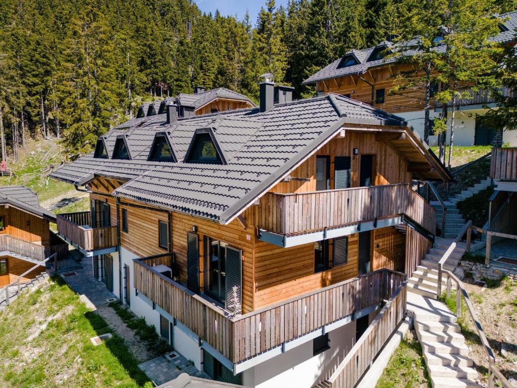 an overhead view of a log home with a metal roof at Apartment MOUNTAIN PEARL Golte in Mozirje
