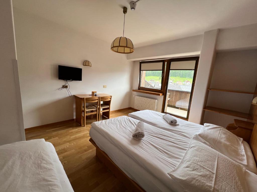 Postel nebo postele na pokoji v ubytování Hotel D'La Varda