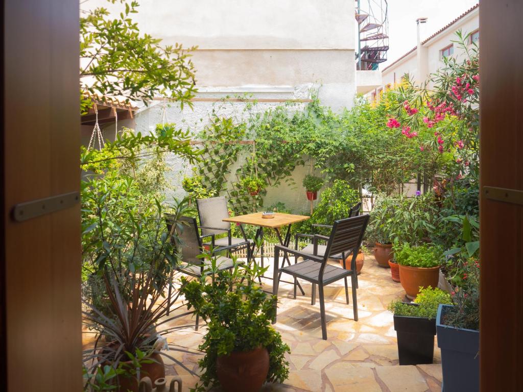 a patio with a table and chairs and plants at Olga's Cozy home in Monemvasia