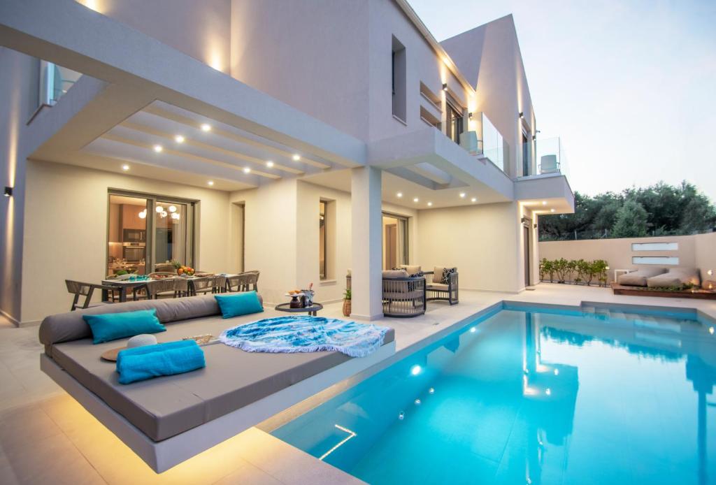 een villa met een zwembad en een huis bij Grande Mandi & Jani Villa in Laganas