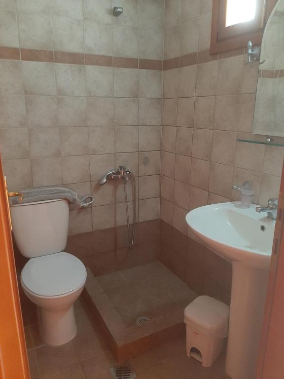 a bathroom with a toilet and a sink at Hotel Kosmas in Sarti