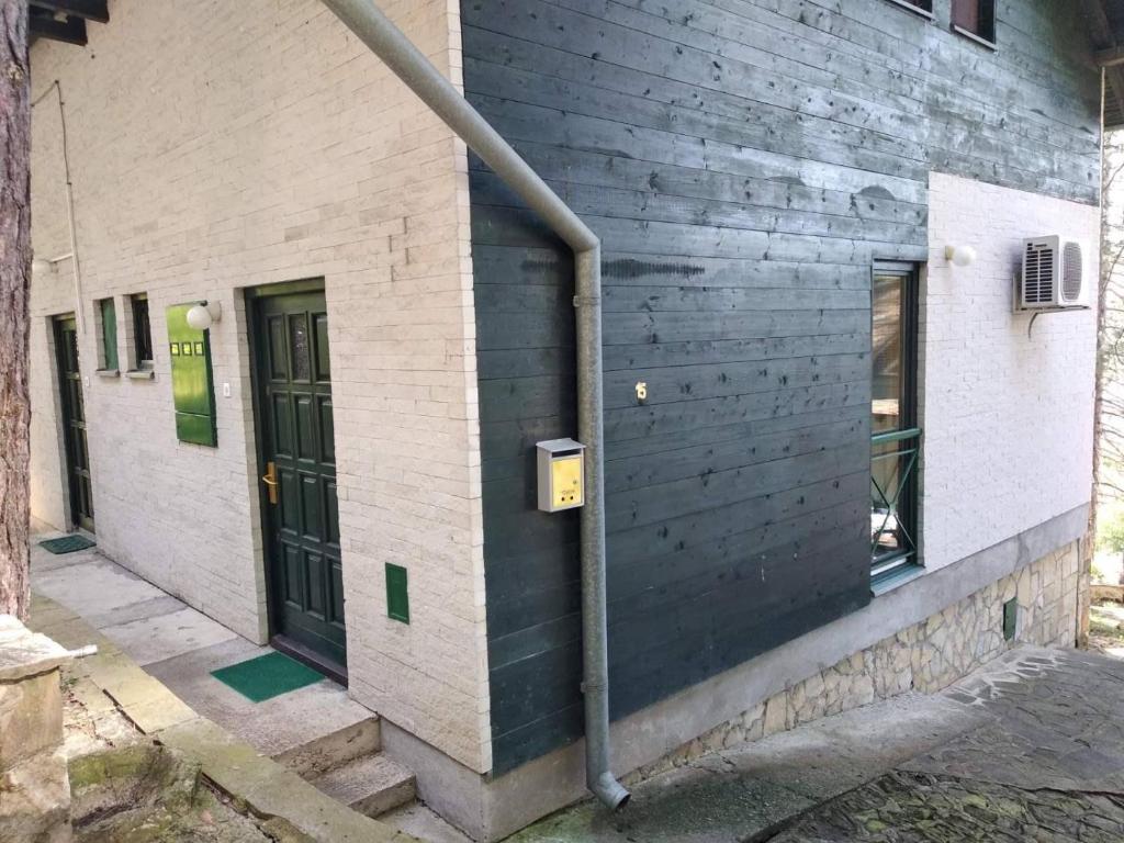 a pipe on the side of a building with a door at Zeleni raj in Vrnjačka Banja