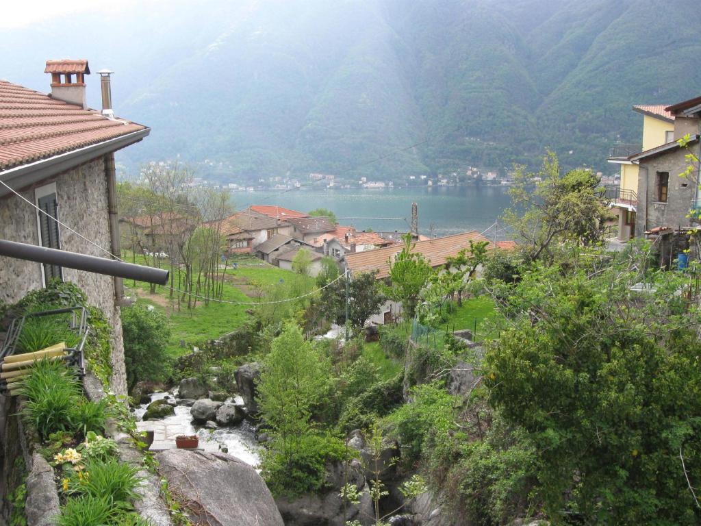 a view of a village with a lake in the background at La Ruota del Mulino in Nesso